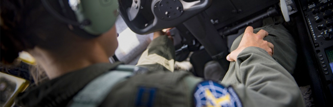 An airmen in the cockpit of a plane.