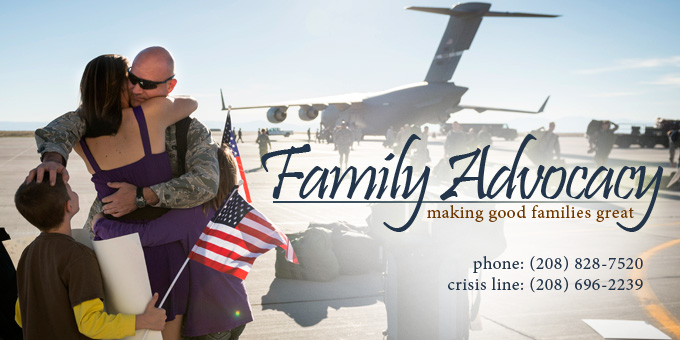 An Airman hugging his wife and family after coming home. Also a banner for Family Advocacy.