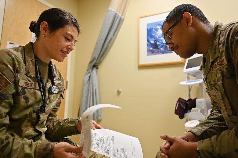 Image of two Airmen learning together