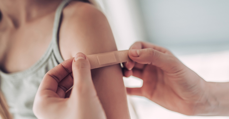 Image of a patient receiving a band aid at the doctor's office
