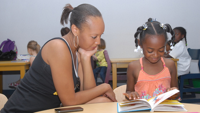 Image of a woman and child reading a book