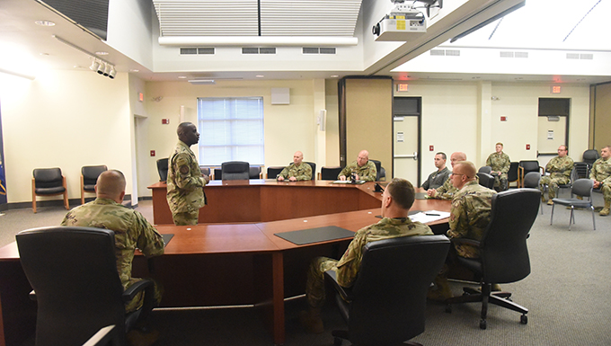 Image of an Airman speaking to a group