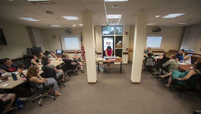 Image of a group of people sitting in a room having a meeting