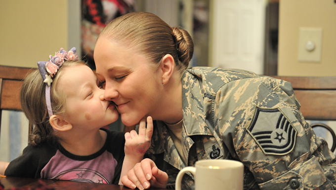 A child kissing her mother.